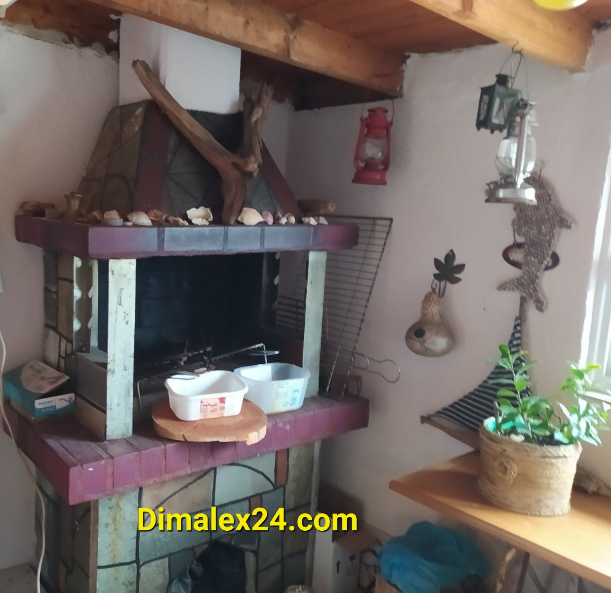 Камината в уютната кухня с дървени акценти и декорации, перфектна за семейни вечери.