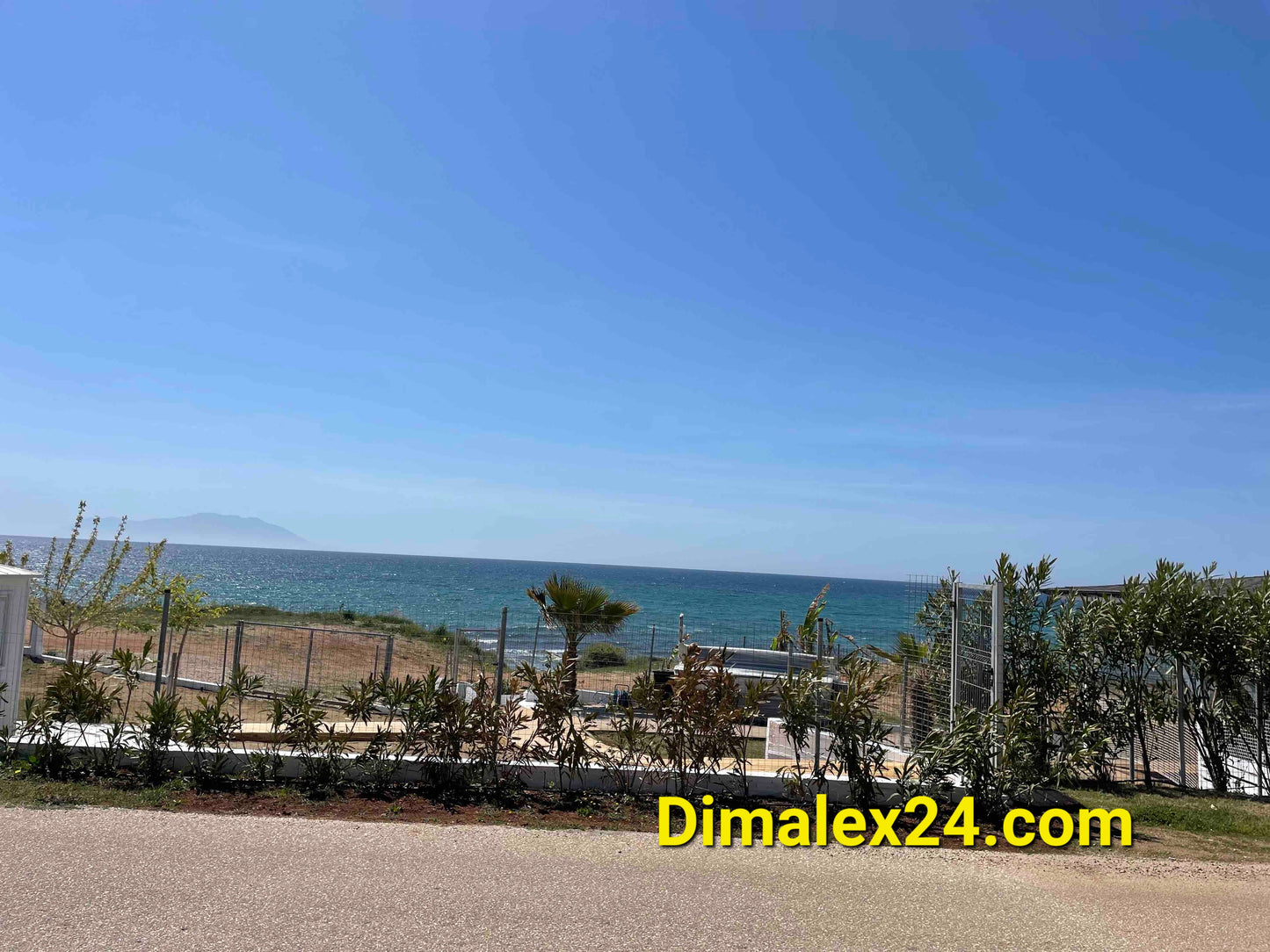Views of the sea from a property in Greece, with lush greenery and beach access.