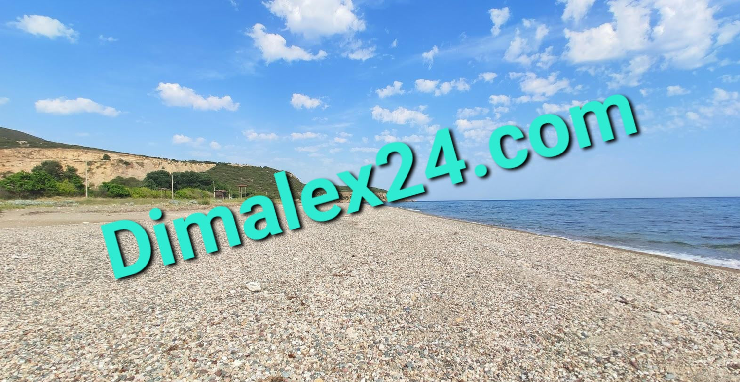 Scenic view of Dikela beach in Evros, Greece, featuring pebbled sand and a serene sea under a blue sky.