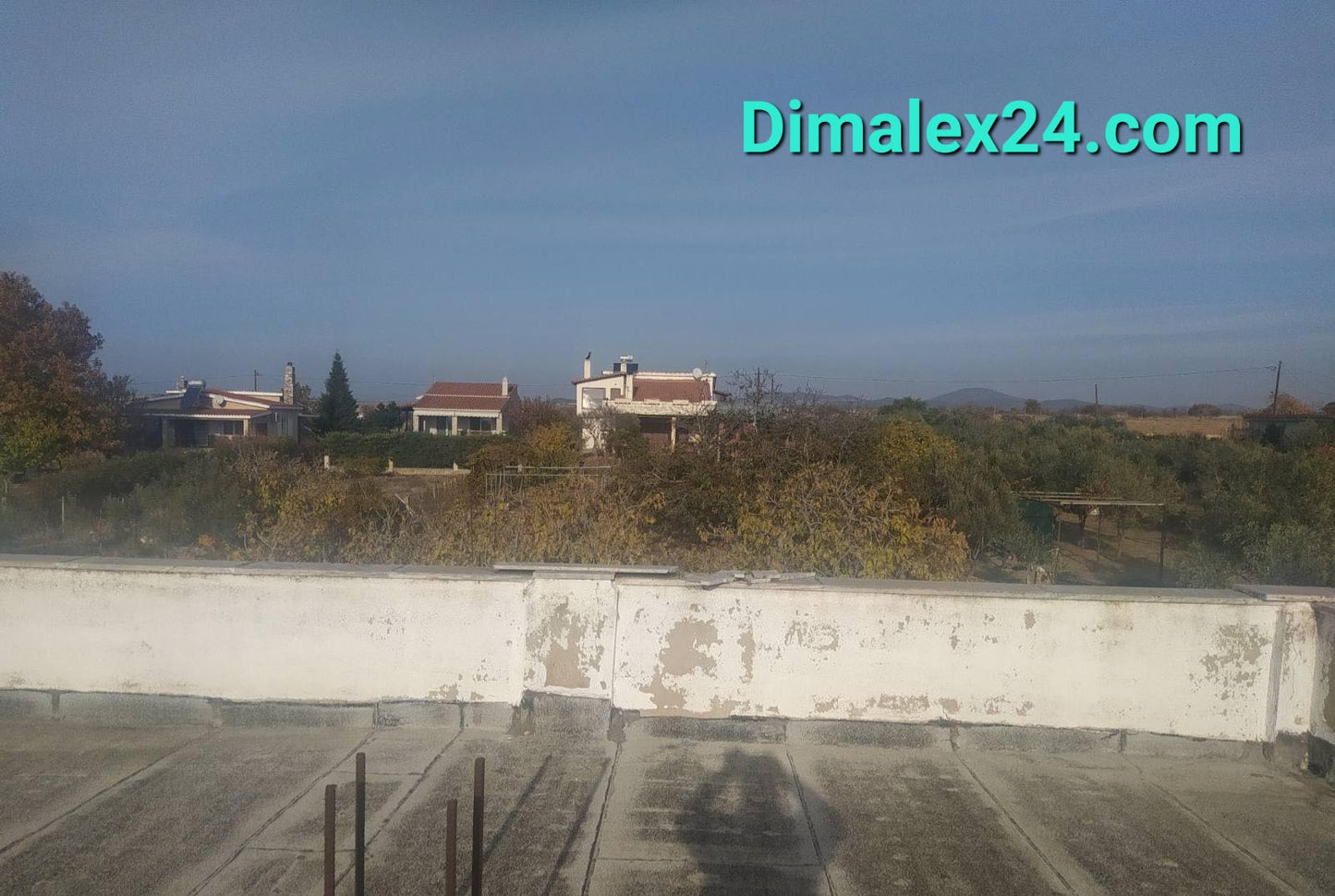 View from the rooftop of a house in Profitis Ilias, Northern Greece, showing surrounding properties and landscape.