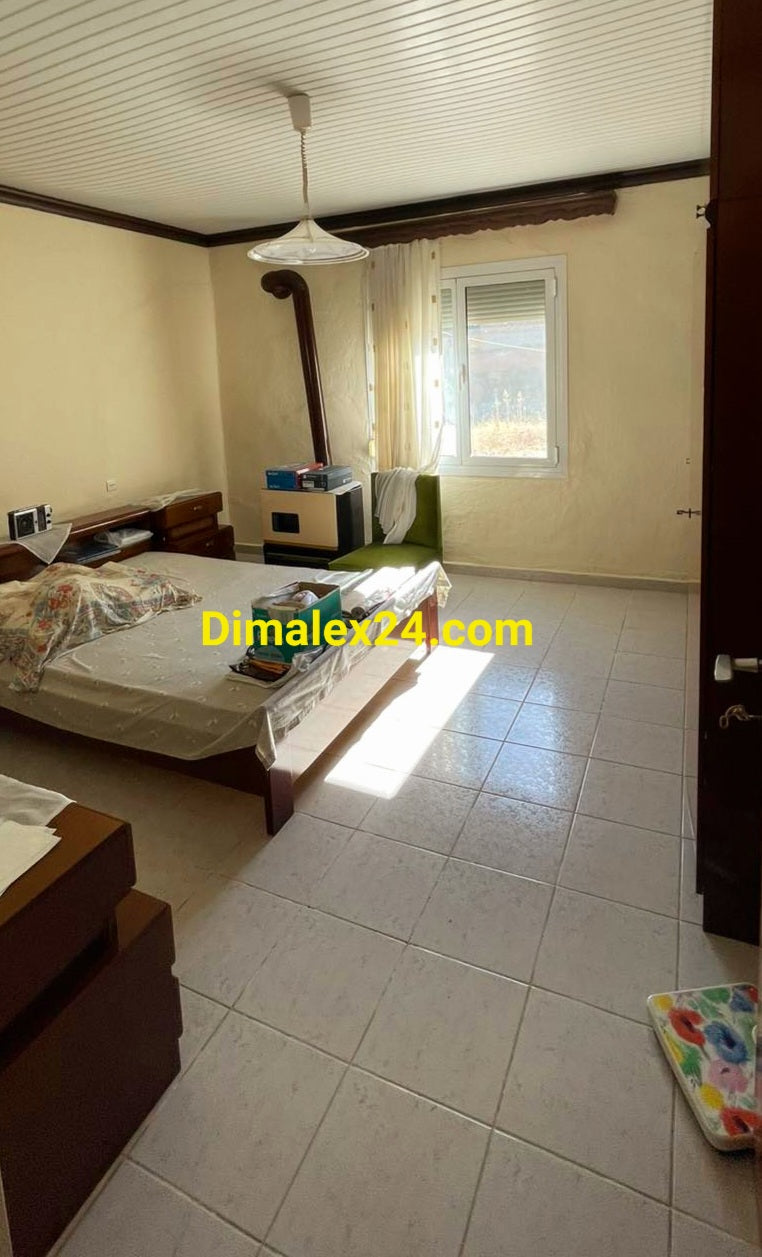 Просторна спалня с голямо легло и алуминиева дограма и ролетни щори  - имот в Северна Гърция.