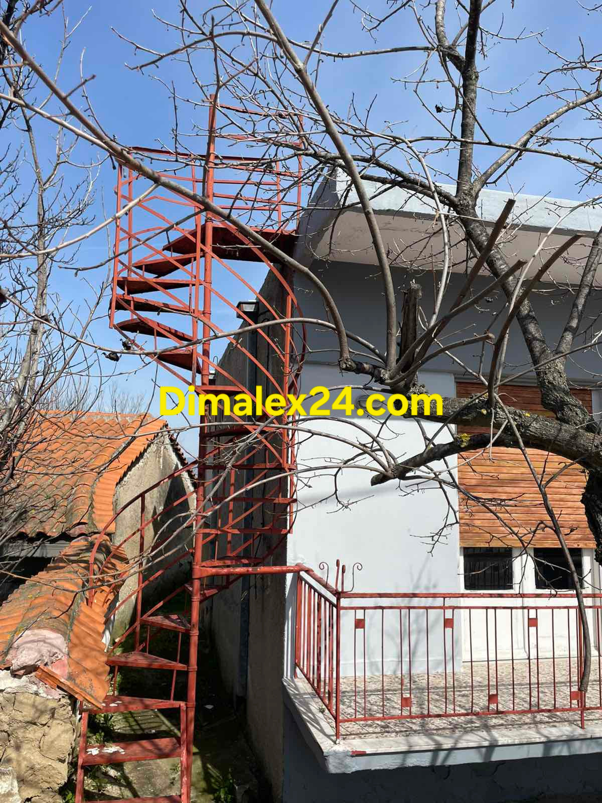 Къща в метална вита стълба водеща към покрива на къщата. Имот близо до морето.