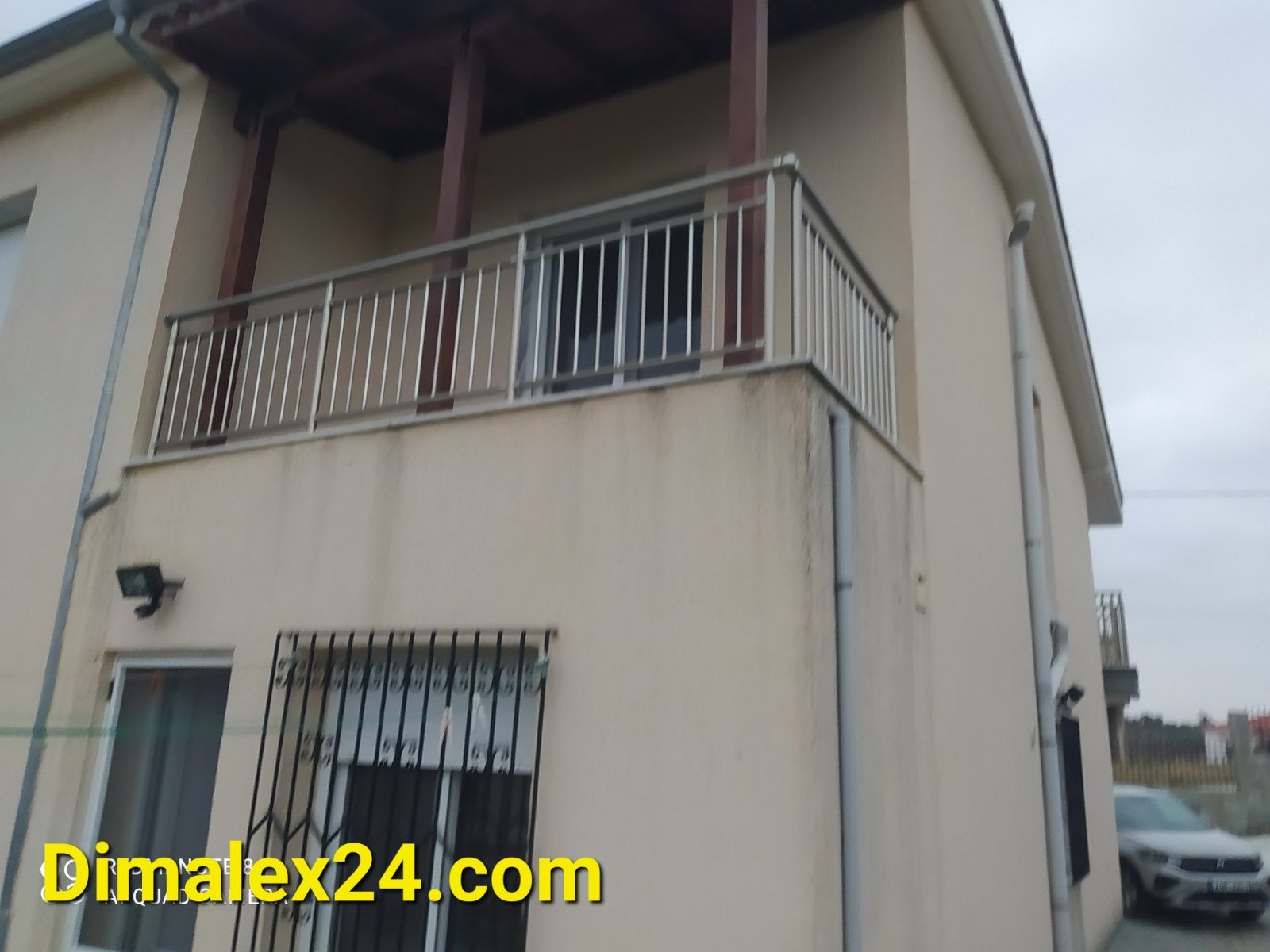 View of the balcony of a two-story house in Ksilagani, Northern Greece, highlighting the exterior design.