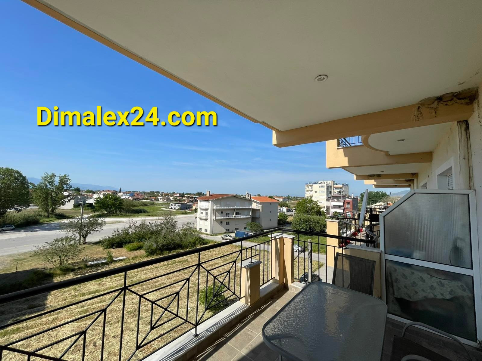 View from balcony of N.58 apartment in Chrisoupoli, Greece, showcasing surrounding landscape and buildings.