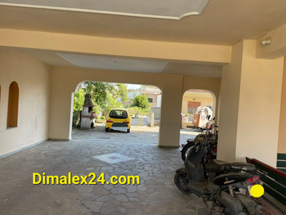 Interior view of parking area in an apartment building in Greece with vehicles and stone floor.