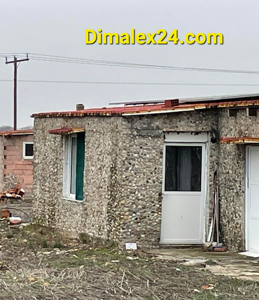 Exterior view of a stone house in Imeros, Northern Greece, highlighting its structure and entrance.